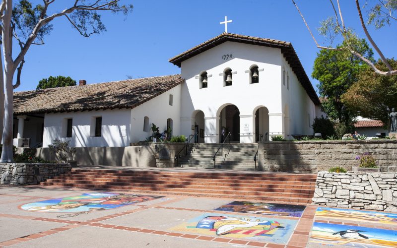 Mission San Luis Obispo de Tolosa with colorful chalk art on the plaza in front